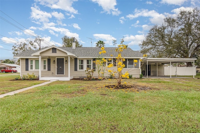 view of front of home featuring a shingled roof, a chimney, a front lawn, and a carport