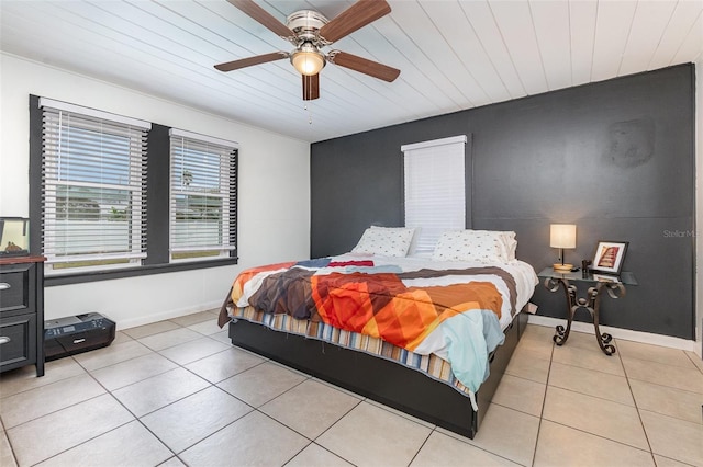 bedroom with wooden ceiling, light tile patterned flooring, ceiling fan, and baseboards