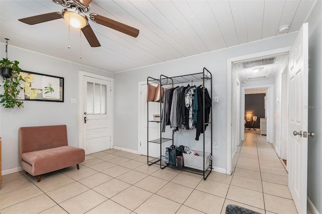 interior space with light tile patterned floors, visible vents, and baseboards