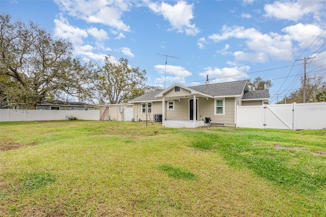 back of house featuring a fenced backyard, a gate, central AC unit, and a lawn