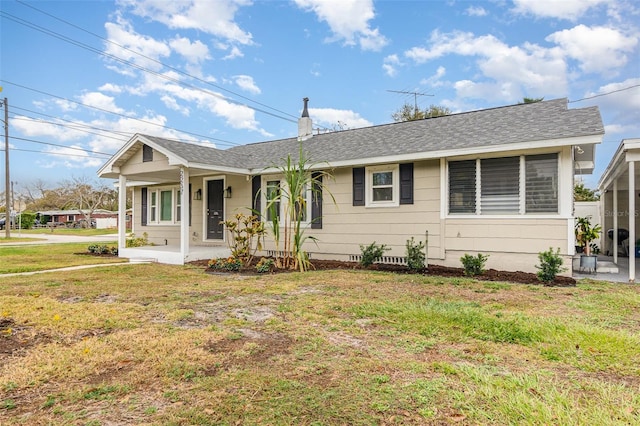 view of front of home with a shingled roof, a chimney, a porch, and a front yard