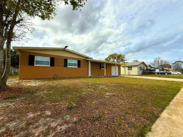 single story home with a garage, a front yard, driveway, and fence