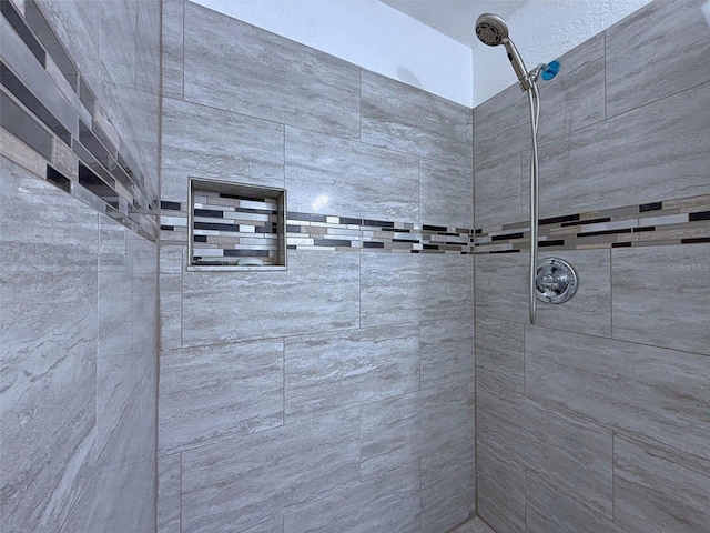 bathroom with a tile shower