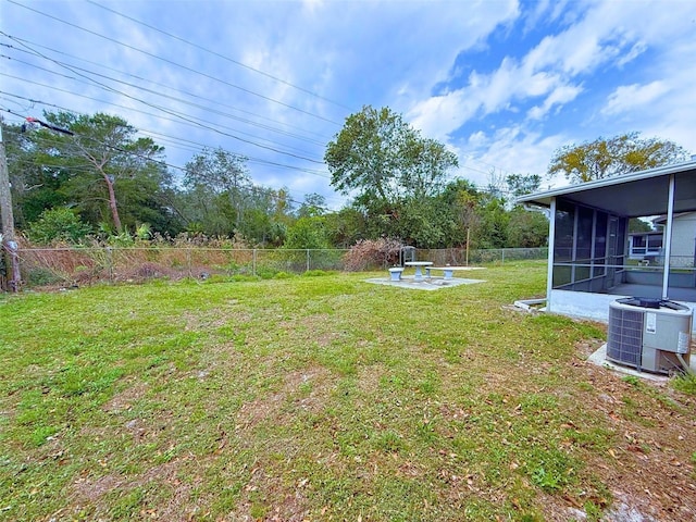 view of yard featuring cooling unit, a sunroom, and a fenced backyard