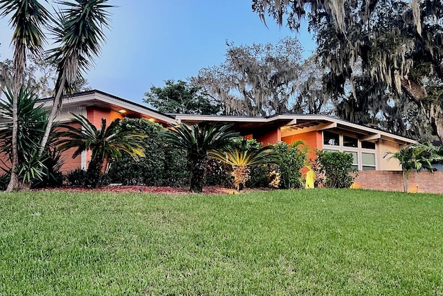 view of home's exterior with a lawn