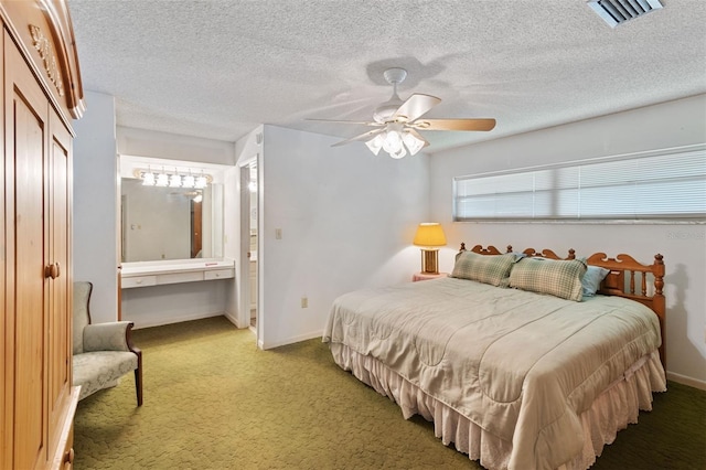 carpeted bedroom featuring baseboards, visible vents, ceiling fan, and a textured ceiling