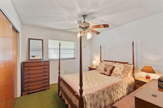 carpeted bedroom featuring a textured ceiling, a closet, and a ceiling fan