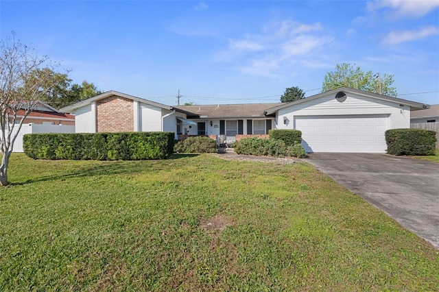 view of front of house with concrete driveway, brick siding, an attached garage, and a front lawn