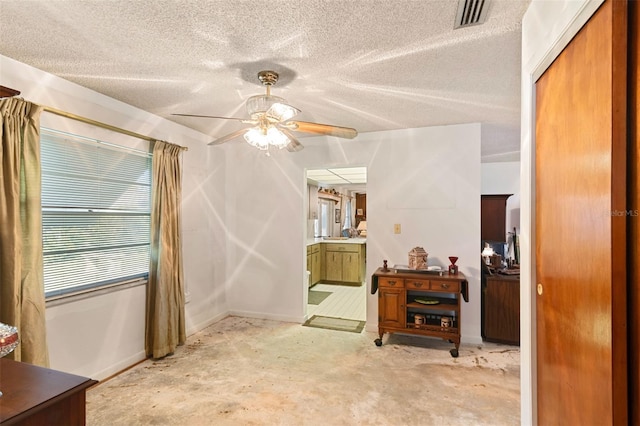 interior space featuring a closet, visible vents, a textured ceiling, and ensuite bathroom