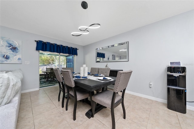 dining room featuring light tile patterned floors and baseboards