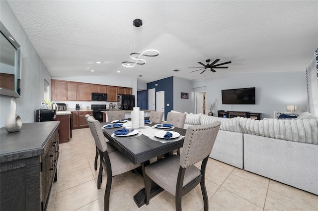 dining area featuring a ceiling fan, lofted ceiling, light tile patterned flooring, and a textured ceiling