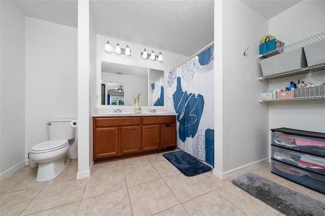 bathroom with a shower with curtain, toilet, a sink, a textured ceiling, and tile patterned flooring