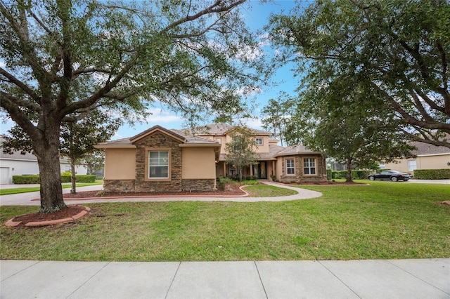 view of front of home featuring stone siding, a front lawn, and stucco siding