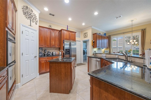 1686 Shadowmoss Cir, Lake Mary, FL 32746 - kitchen featuring an island with sink, appliances with stainless steel finishes, a sink, ornamental molding, and tasteful backsplash