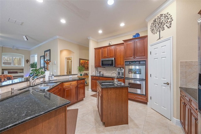 1686 Shadowmoss Cir, Lake Mary, FL 32746 - kitchen featuring a sink, stainless steel appliances, a spacious island, ornamental molding, and tasteful backsplash