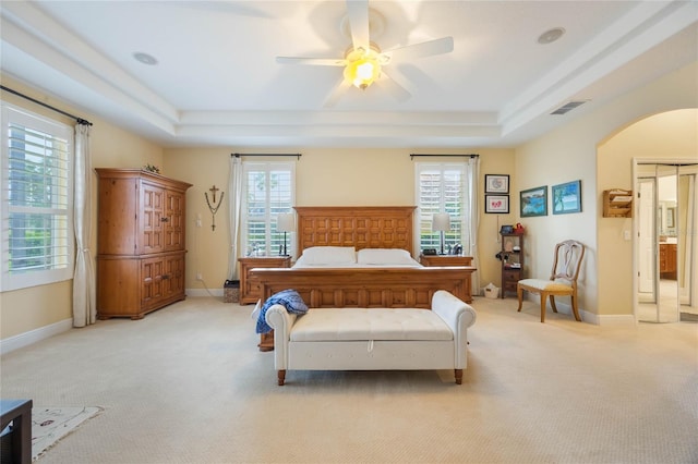 1686 Shadowmoss Cir, Lake Mary, FL 32746 - bedroom featuring a raised ceiling, light carpet, and arched walkways