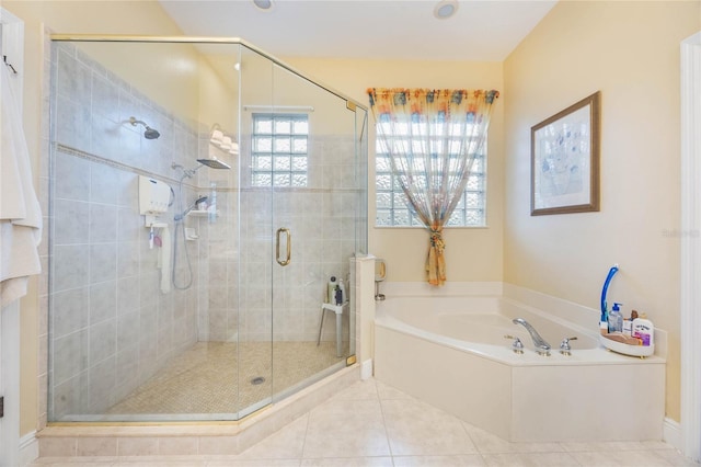 1686 Shadowmoss Cir, Lake Mary, FL 32746 - full bath with tile patterned floors, a shower stall, and a garden tub