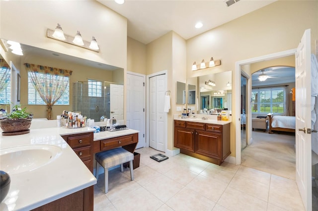 1686 Shadowmoss Cir, Lake Mary, FL 32746 - full bath featuring a shower stall, two vanities, tile patterned floors, a ceiling fan, and baseboards