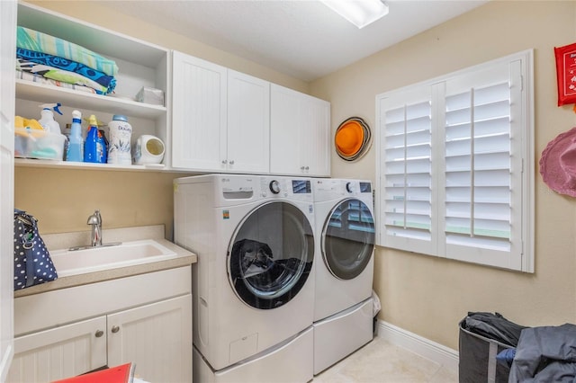 1686 Shadowmoss Cir, Lake Mary, FL 32746 - washroom with washing machine and clothes dryer, cabinet space, baseboards, and light tile patterned floors