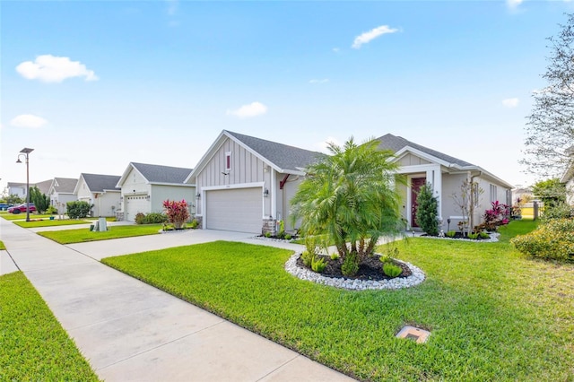 view of front of home with driveway, a front lawn, board and batten siding, and a residential view