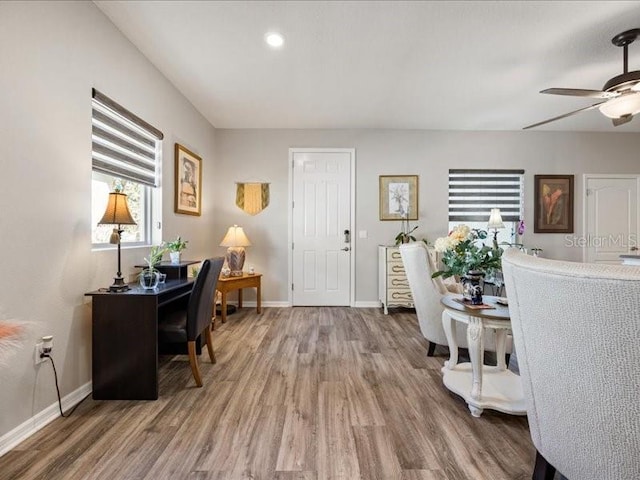 office space with a ceiling fan, baseboards, and wood finished floors