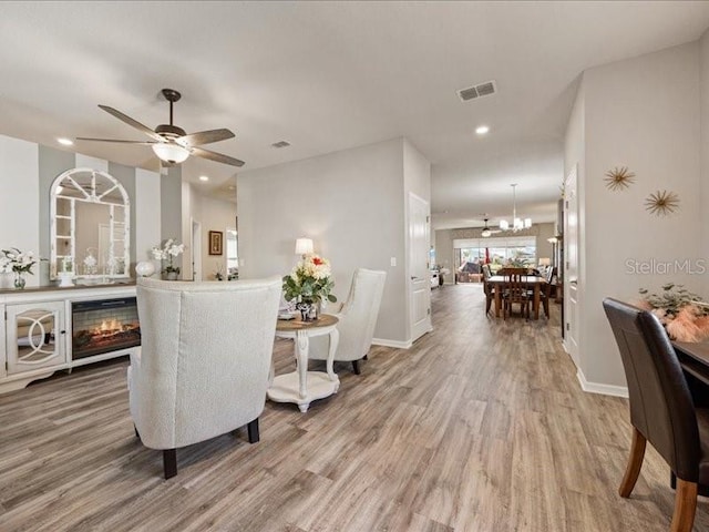 bar featuring light wood-type flooring, visible vents, and baseboards