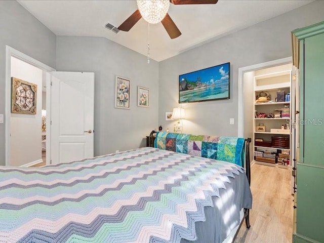 bedroom featuring ceiling fan, visible vents, and wood finished floors