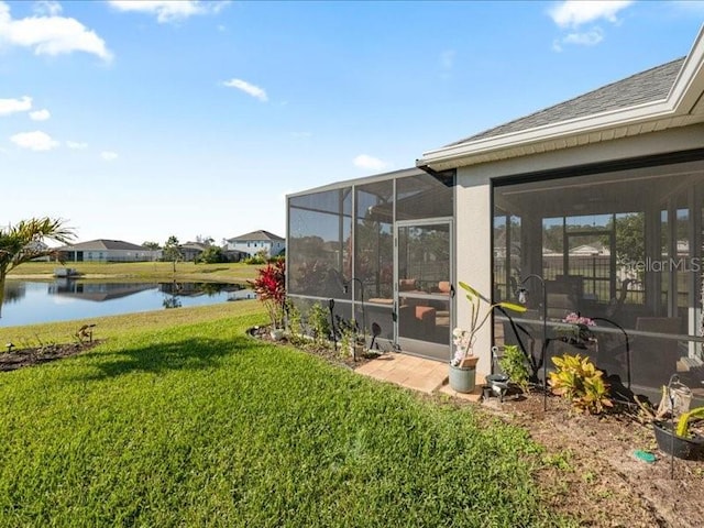 view of yard with a water view and a sunroom