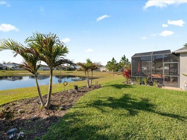 view of yard featuring glass enclosure and a water view