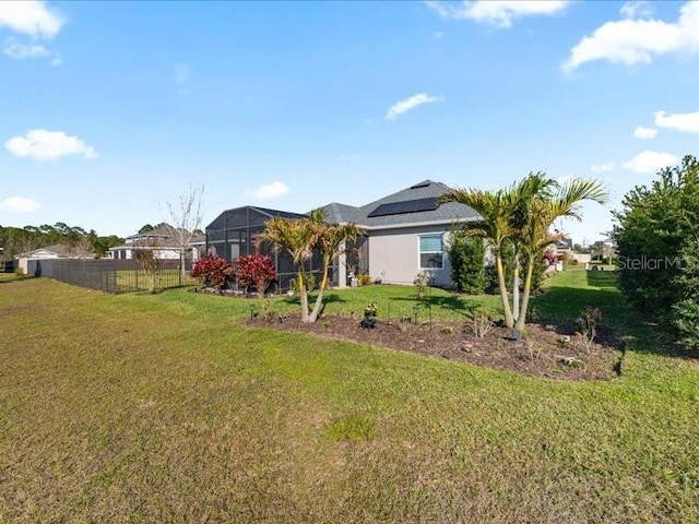 view of yard featuring a lanai and fence