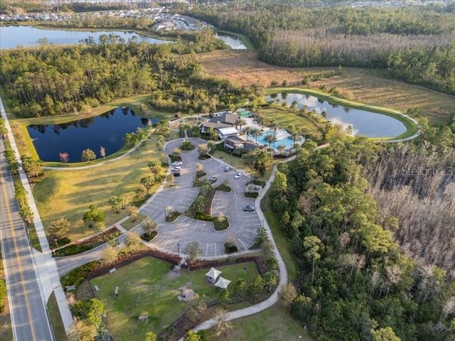 bird's eye view with a water view and a view of trees