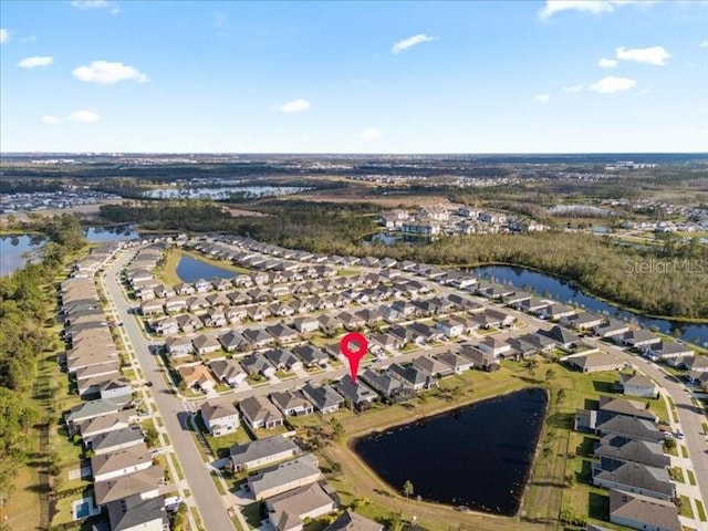 drone / aerial view featuring a water view and a residential view
