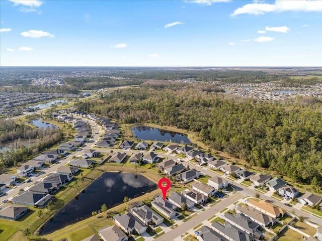 birds eye view of property featuring a wooded view, a residential view, and a water view