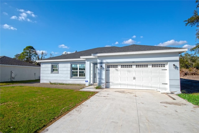 ranch-style home featuring a garage, driveway, and a front lawn