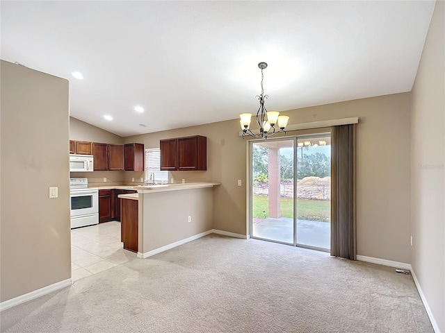 kitchen with lofted ceiling, white appliances, light countertops, and light colored carpet