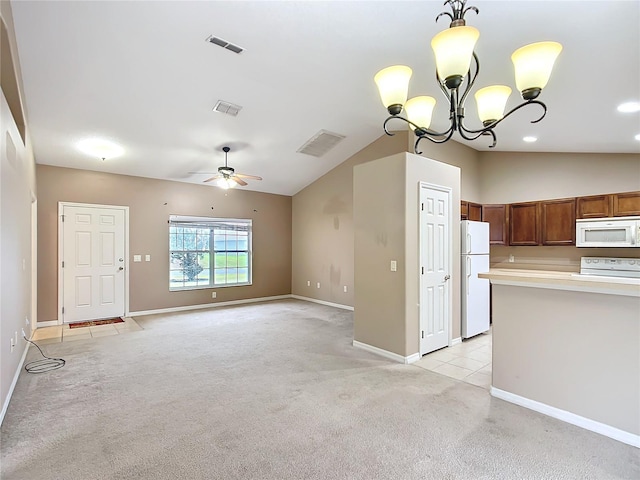 kitchen with white appliances, light colored carpet, vaulted ceiling, and visible vents