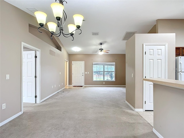 entryway with light colored carpet, ceiling fan with notable chandelier, visible vents, baseboards, and vaulted ceiling