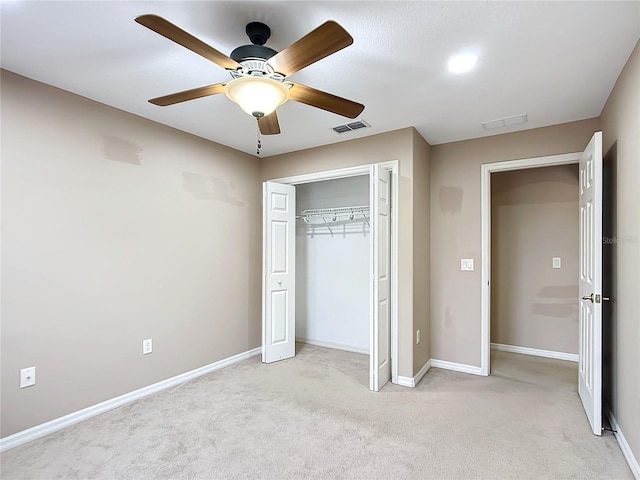 unfurnished bedroom with light colored carpet, a ceiling fan, visible vents, baseboards, and a closet