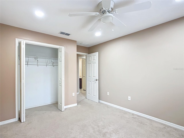 unfurnished bedroom with light carpet, a ceiling fan, visible vents, baseboards, and a closet