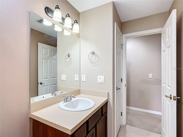 bathroom with visible vents, vanity, baseboards, and tile patterned floors