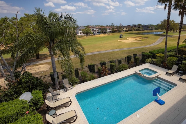 view of pool with a yard, a pool with connected hot tub, a patio, and fence