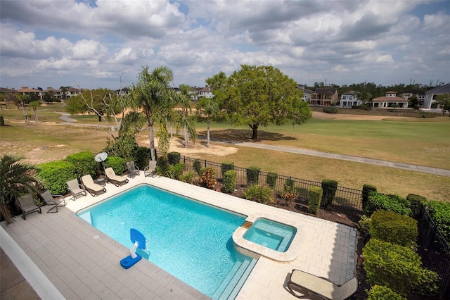 view of swimming pool with a patio area, a fenced backyard, a lawn, and a pool with connected hot tub