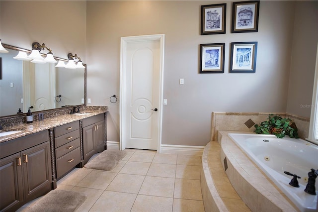 bathroom featuring a sink, a whirlpool tub, double vanity, and tile patterned floors