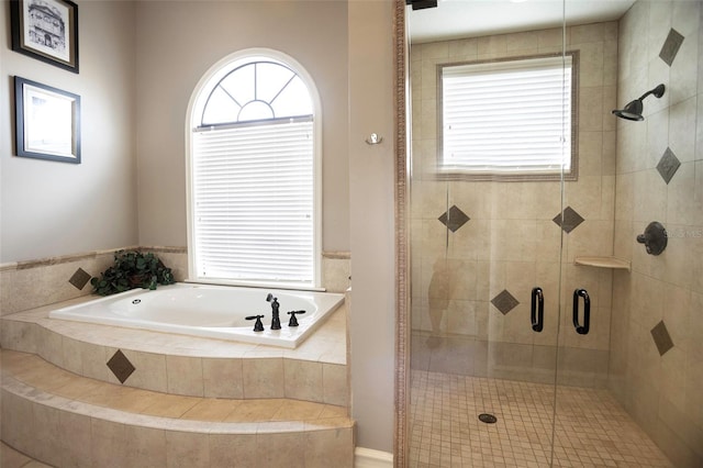 full bathroom with a bath, a healthy amount of sunlight, and a stall shower