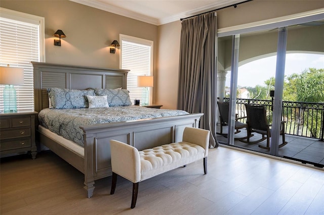 bedroom featuring crown molding, access to outside, and wood finished floors