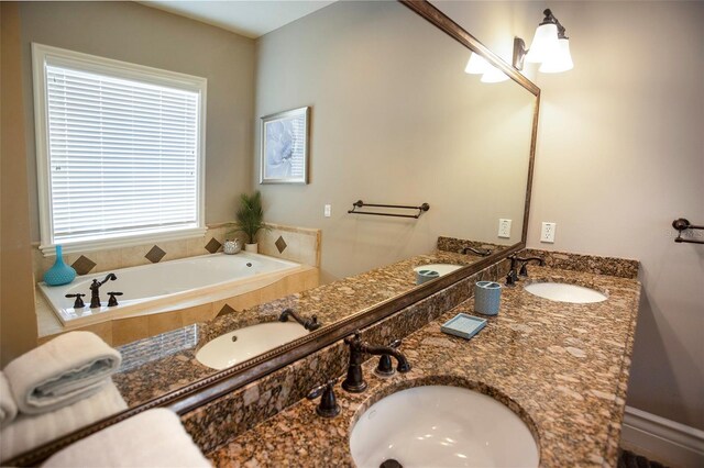 bathroom featuring a bath and a sink