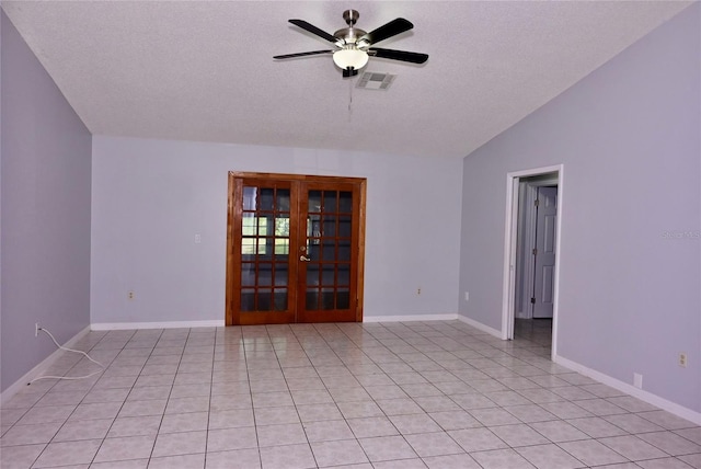 spare room with french doors, light tile patterned floors, lofted ceiling, visible vents, and a ceiling fan