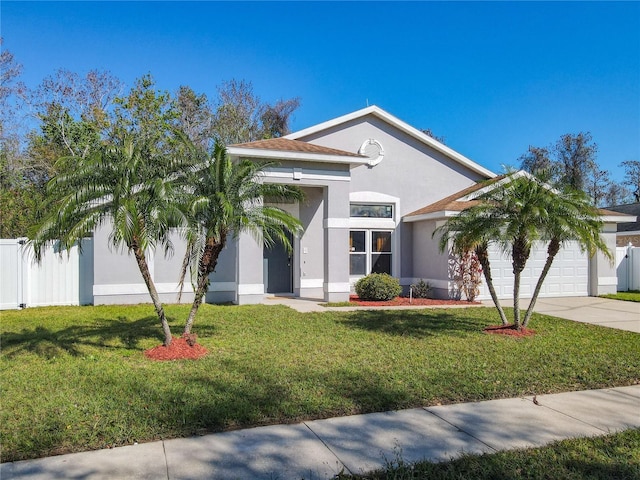 view of front of home with a garage, a front yard, concrete driveway, and stucco siding