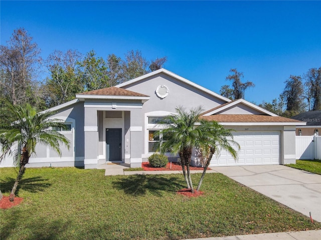 view of front of home with a garage, concrete driveway, a front lawn, and stucco siding