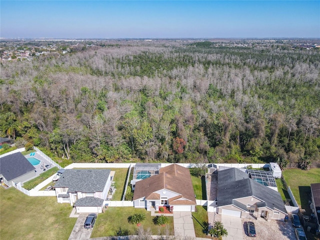 aerial view with a wooded view and a residential view